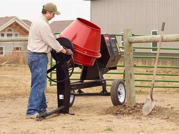 photo of man using concrete mixer